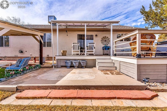 back of house with a patio area and stucco siding