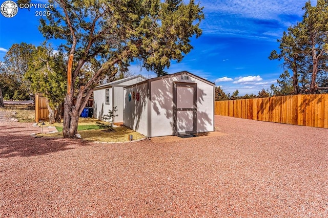 view of shed with fence