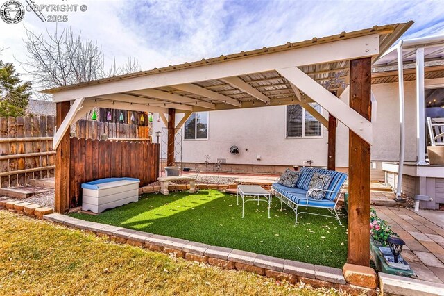 exterior space featuring outdoor lounge area and fence