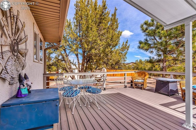 wooden deck featuring outdoor dining space