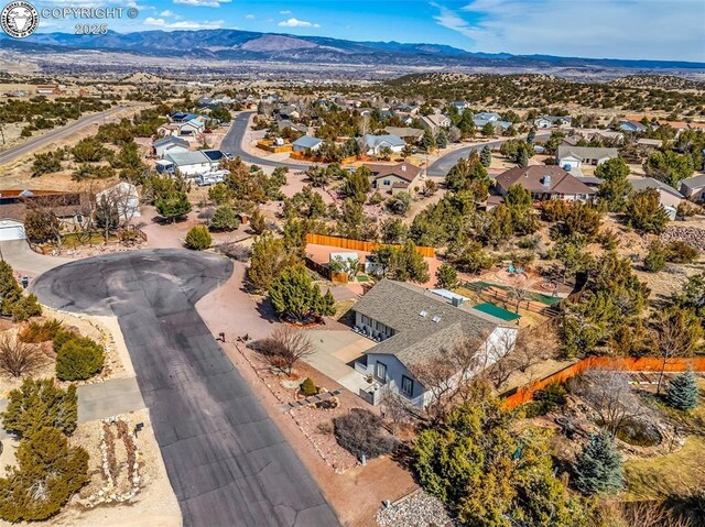 drone / aerial view featuring a residential view and a mountain view