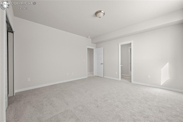 unfurnished bedroom with baseboards and light colored carpet