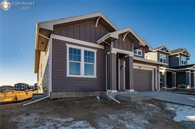 view of front facade featuring a garage, driveway, and board and batten siding