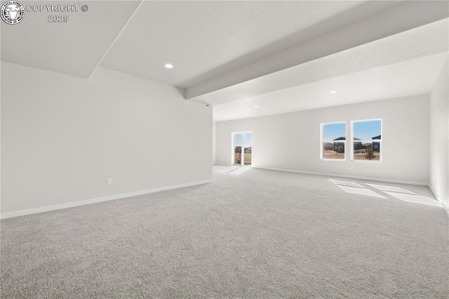 spare room featuring carpet floors, recessed lighting, and baseboards