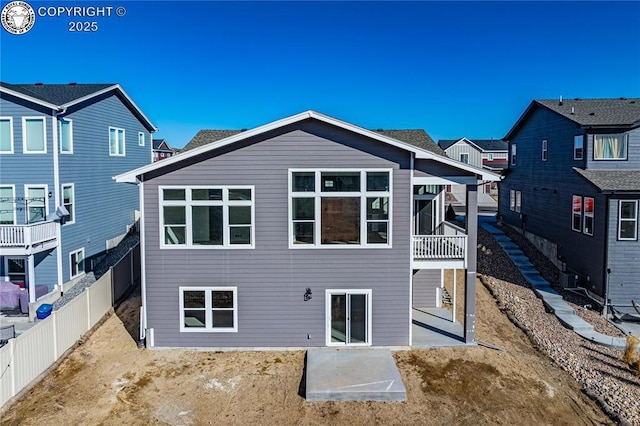 rear view of property featuring central air condition unit, a patio area, and fence