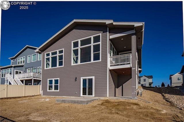 back of property featuring a patio and fence