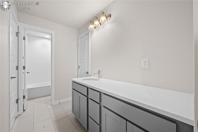 bathroom featuring vanity, baseboards, and tile patterned floors