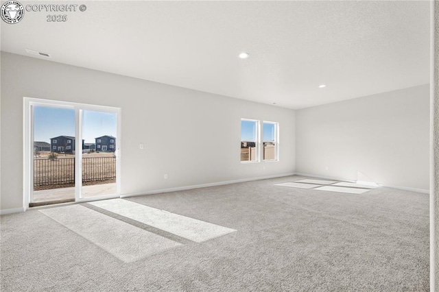 spare room with carpet, baseboards, and recessed lighting