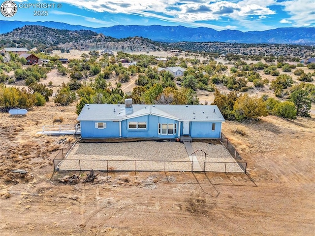 birds eye view of property featuring a mountain view