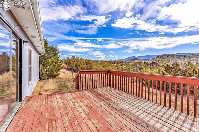 wooden deck with a mountain view