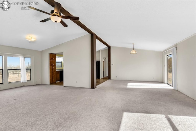 unfurnished room with ceiling fan, vaulted ceiling, and light colored carpet