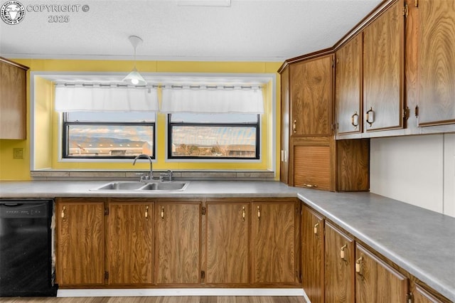 kitchen featuring a sink, light countertops, brown cabinets, dishwasher, and pendant lighting