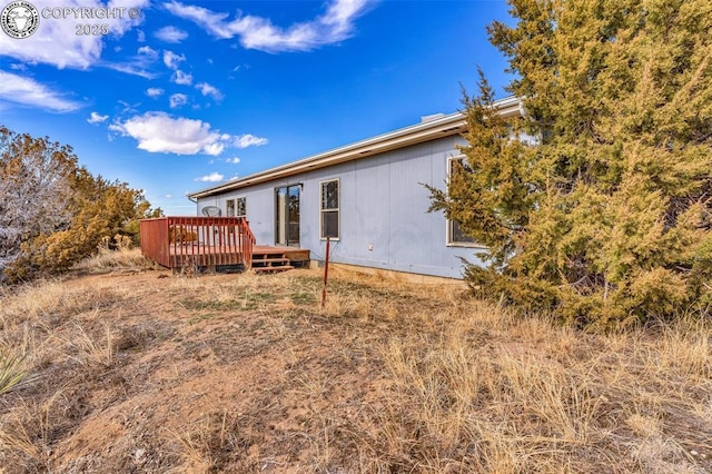 back of house featuring a wooden deck