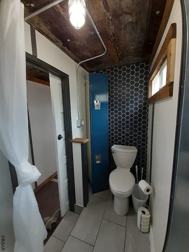 bathroom featuring tile patterned floors and toilet