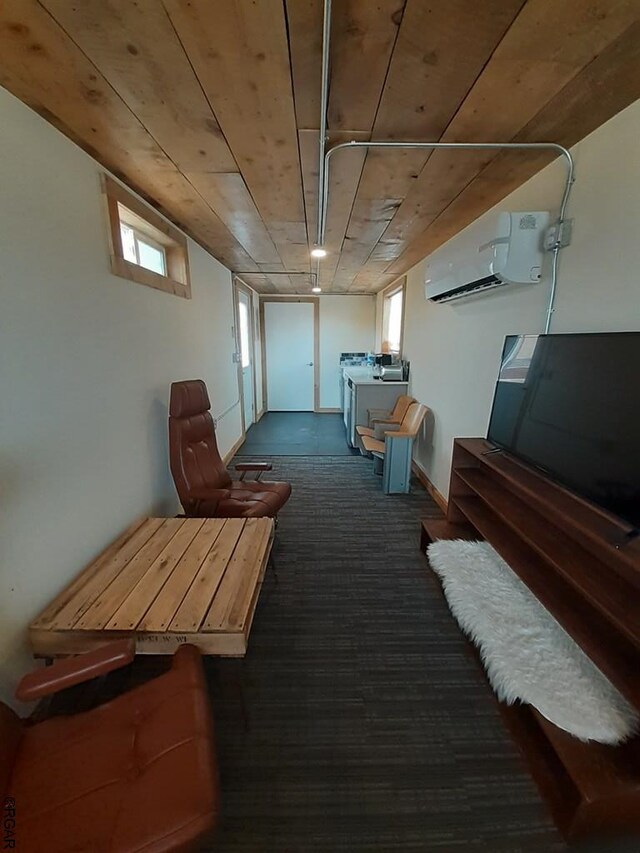 basement with dark colored carpet, a wealth of natural light, and an AC wall unit