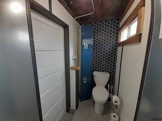 bathroom featuring toilet and tile patterned flooring