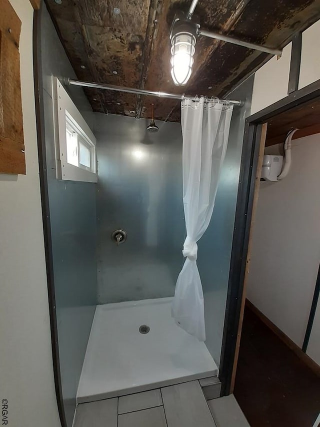 bathroom featuring curtained shower and tile patterned flooring