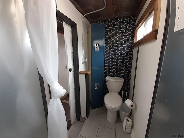 bathroom with tile patterned flooring and toilet