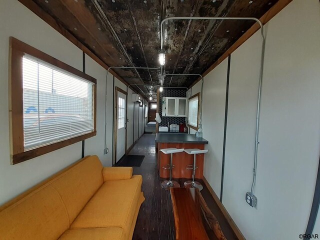 interior space featuring plenty of natural light and dark hardwood / wood-style flooring