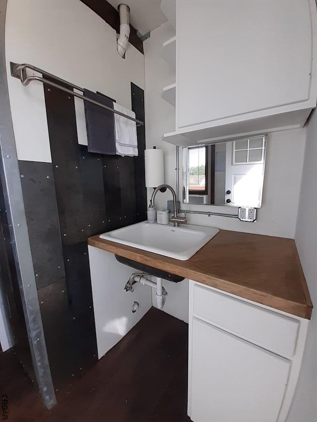 kitchen featuring white cabinetry and sink