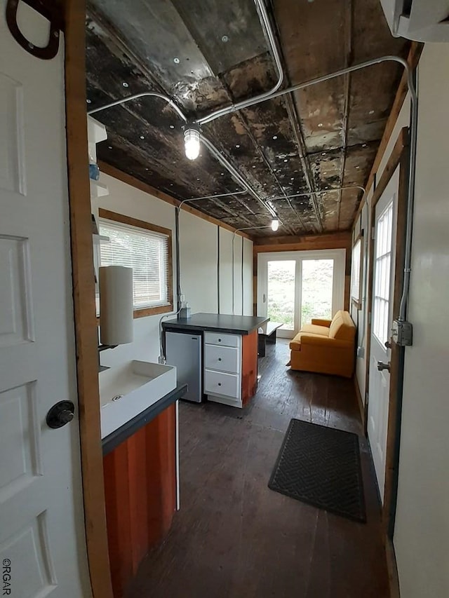 interior space featuring fridge and white cabinets