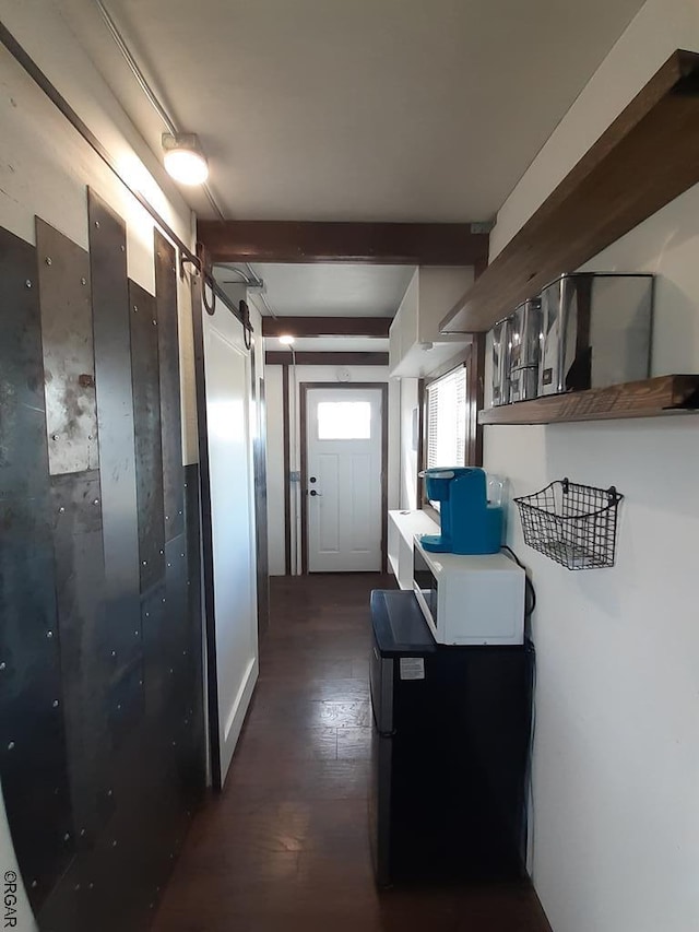 hallway featuring beam ceiling