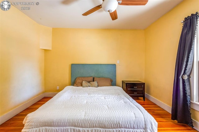 bedroom with hardwood / wood-style flooring and ceiling fan