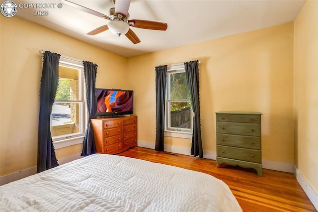 bedroom with hardwood / wood-style flooring and ceiling fan