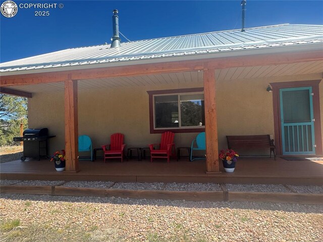 214 Durfee Cir, Westcliffe, CO 81252 - rear view of property with stucco siding, metal roof, and a porch