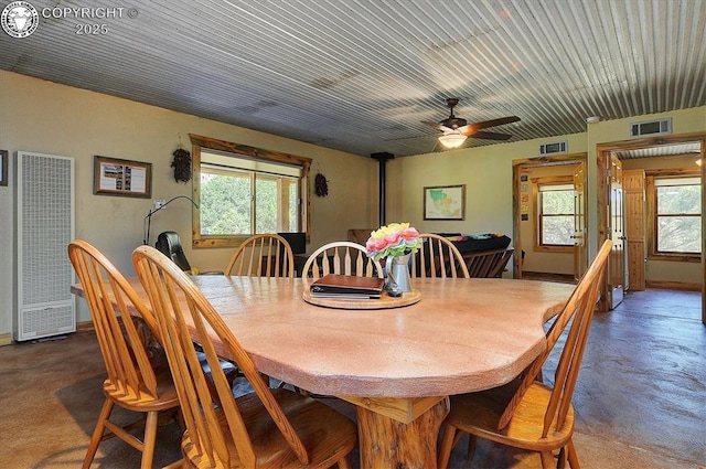 214 Durfee Cir, Westcliffe, CO 81252 - dining space featuring a heating unit, plenty of natural light, a ceiling fan, and finished concrete floors