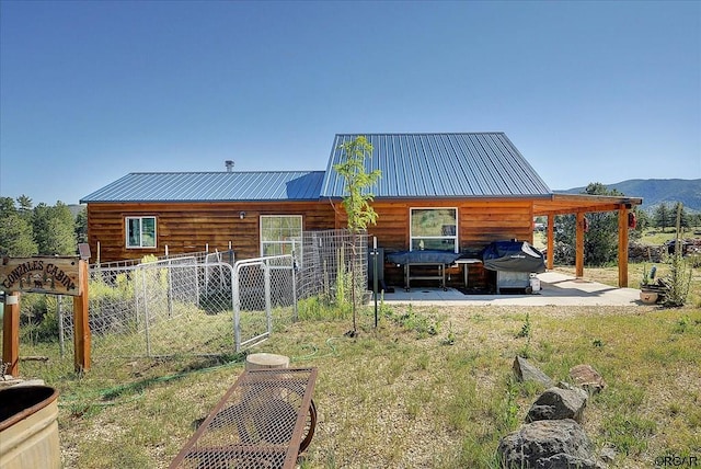 back of house with a mountain view