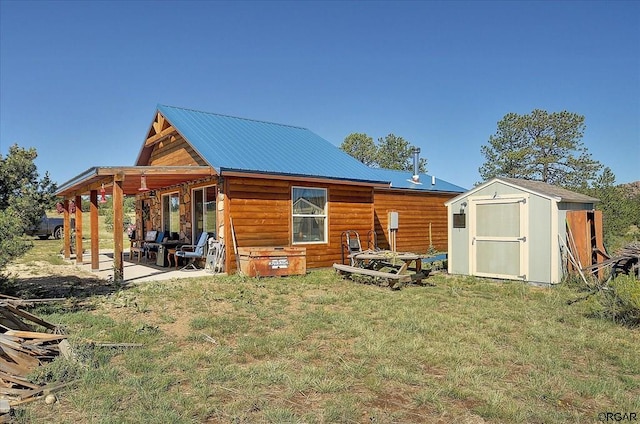 rear view of house featuring a storage shed and a lawn