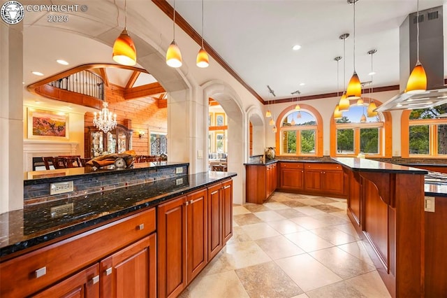 324 Elk View Ct, Canon City, CO 81212 - kitchen with decorative light fixtures, dark stone counters, island range hood, and an inviting chandelier