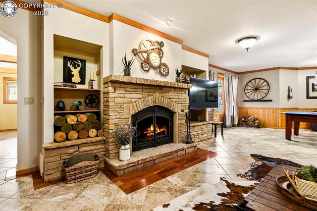 324 Elk View Ct, Canon City, CO 81212 - living room with pool table, wainscoting, a fireplace, and ornamental molding