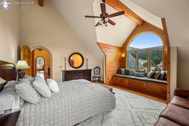 324 Elk View Ct, Canon City, CO 81212 - bedroom featuring high vaulted ceiling, ceiling fan, arched walkways, wood finished floors, and beam ceiling
