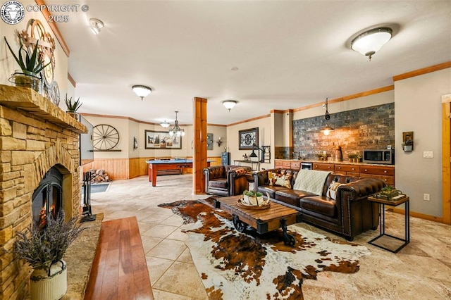 324 Elk View Ct, Canon City, CO 81212 - living room featuring ornamental molding, billiards, wainscoting, and a glass covered fireplace