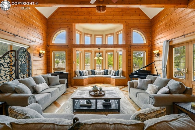 324 Elk View Ct, Canon City, CO 81212 - living area featuring wood walls, plenty of natural light, high vaulted ceiling, and ceiling fan