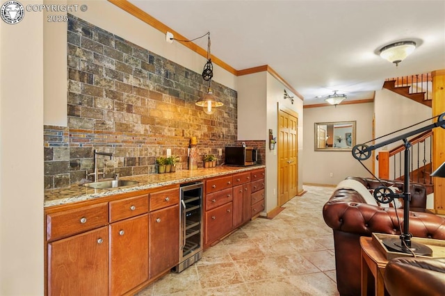 324 Elk View Ct, Canon City, CO 81212 - kitchen with tasteful backsplash, ornamental molding, brown cabinetry, wine cooler, and a sink