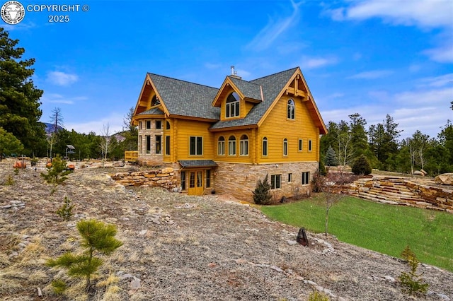 324 Elk View Ct, Canon City, CO 81212 - rear view of house with a shingled roof, stone siding, and a lawn