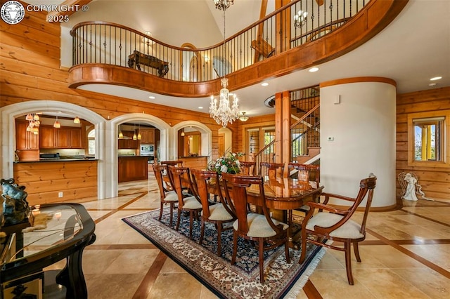 324 Elk View Ct, Canon City, CO 81212 - dining room with an inviting chandelier, recessed lighting, wooden walls, stairs, and arched walkways