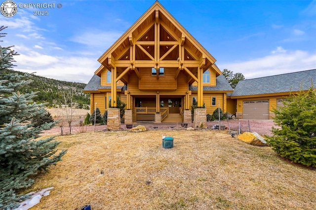 324 Elk View Ct, Canon City, CO 81212 - back of property with stone siding, covered porch, and a garage