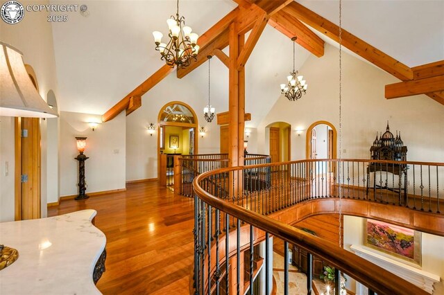 324 Elk View Ct, Canon City, CO 81212 - hall with wood finished floors, an inviting chandelier, beam ceiling, and an upstairs landing