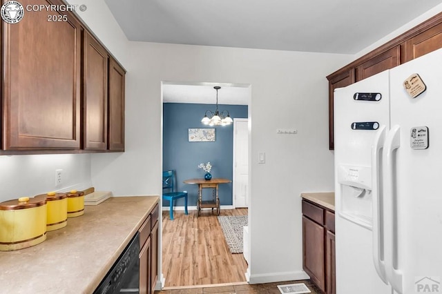 kitchen with dishwasher, light wood-type flooring, hanging light fixtures, white refrigerator with ice dispenser, and an inviting chandelier