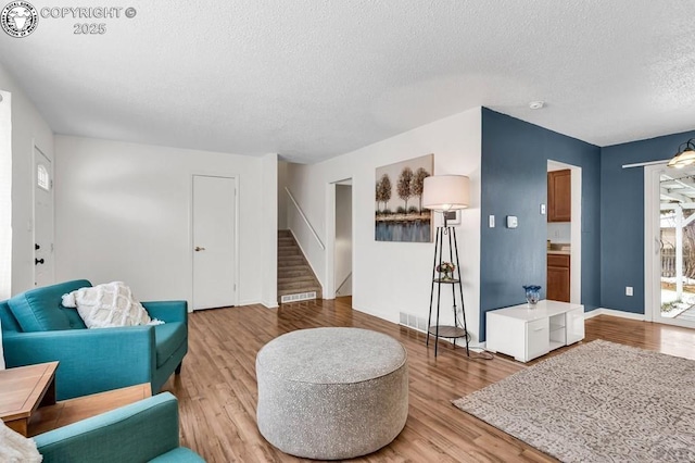 sitting room featuring hardwood / wood-style flooring and a textured ceiling