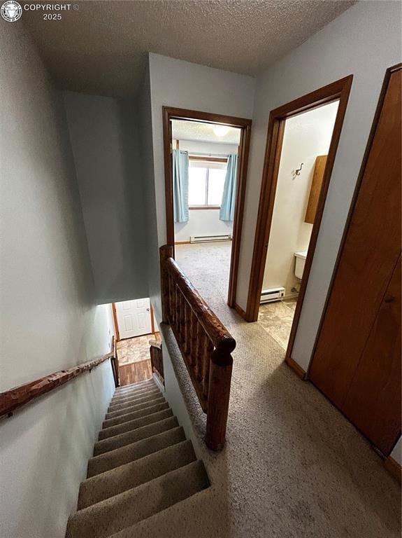9 Granada Ct Unit 5, Westcliffe, CO 81252 - stairs featuring a baseboard radiator, a textured ceiling, and carpet flooring