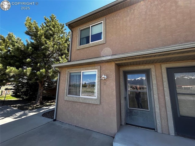 9 Granada Ct Unit 5, Westcliffe, CO 81252 - view of exterior entry with stucco siding and a patio area