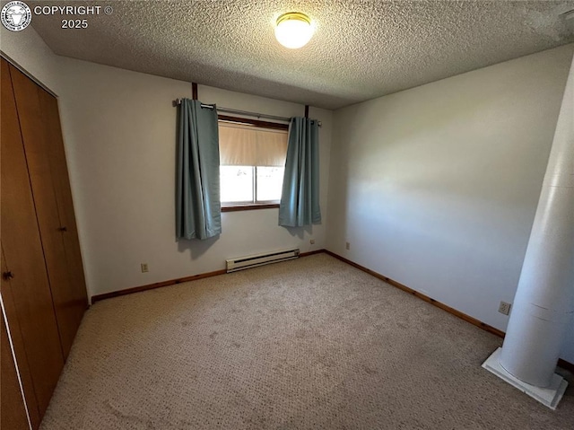 9 Granada Ct Unit 5, Westcliffe, CO 81252 - unfurnished bedroom featuring a baseboard heating unit, a textured ceiling, carpet, a closet, and baseboards