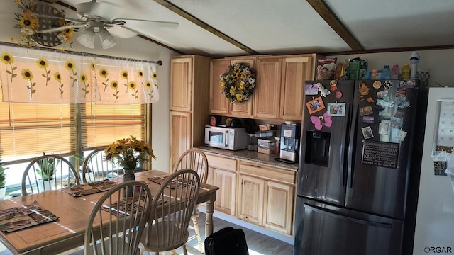 kitchen featuring light brown cabinetry, lofted ceiling, fridge, ceiling fan, and black fridge with ice dispenser