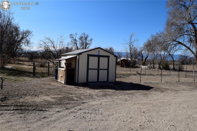 view of shed with fence