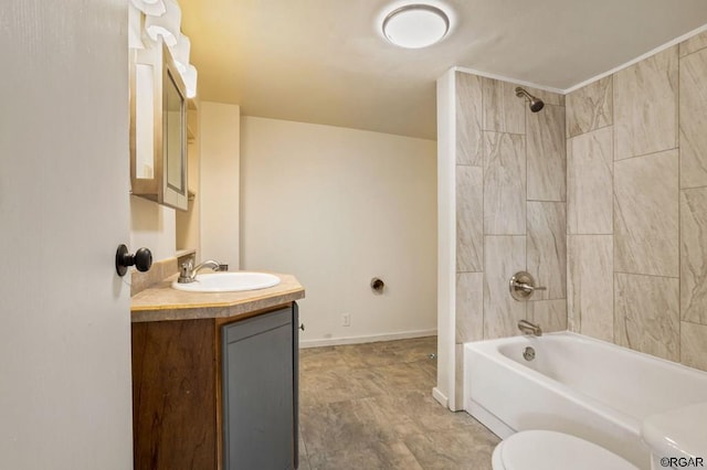 full bathroom with tiled shower / bath, vanity, and toilet